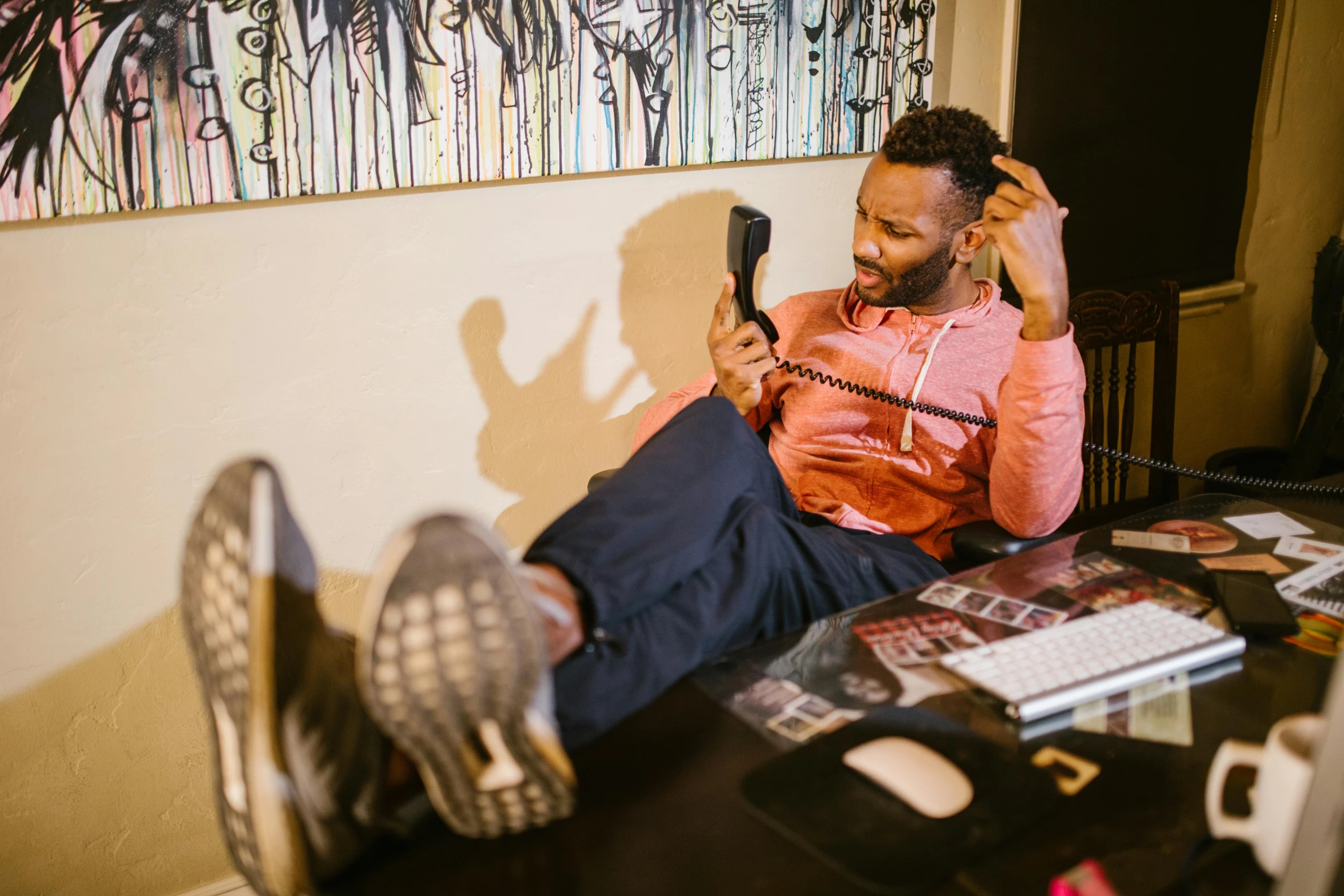 a man is talking on a phone while sitting down