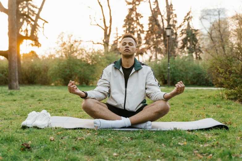 man practicing yoga outdoors on a sunny day