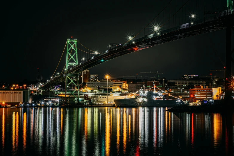 the lights shine brightly on the city of bay bridge