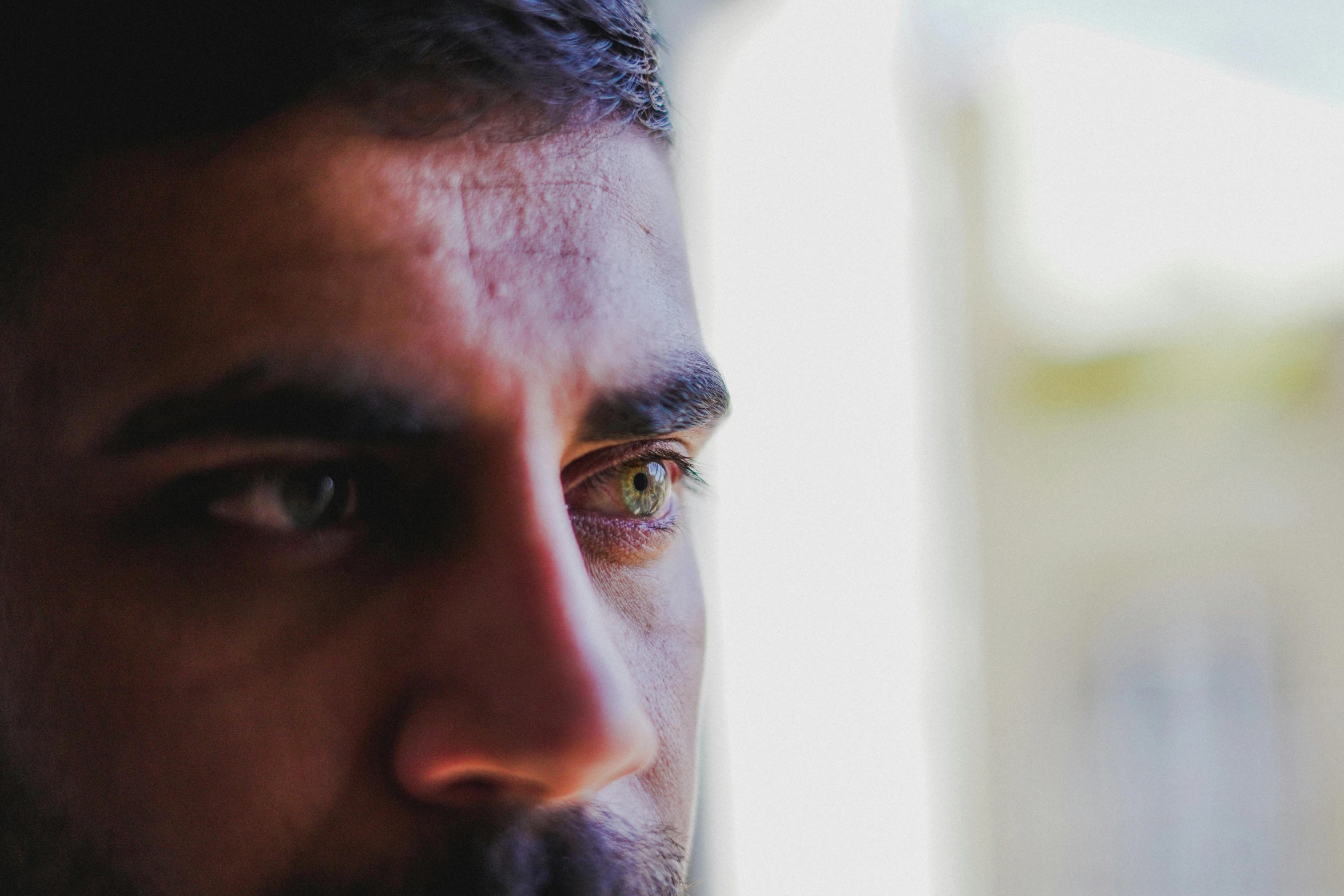 a man looks out of a window and stares away