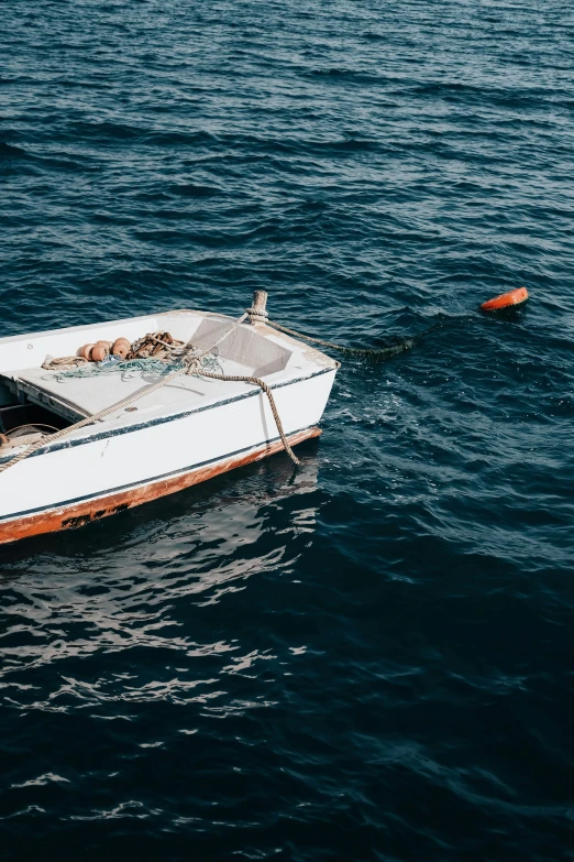 small boat with people inside floats across a body of water