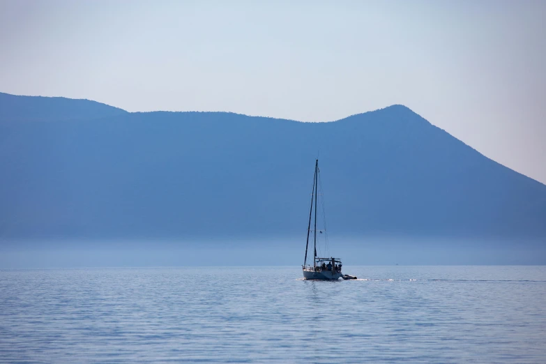 a boat floats in the middle of calm water