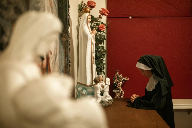 the nun is looking at herself in the mirror