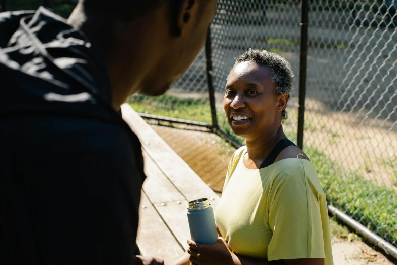 a woman holding a coffee cup and smiling at her man