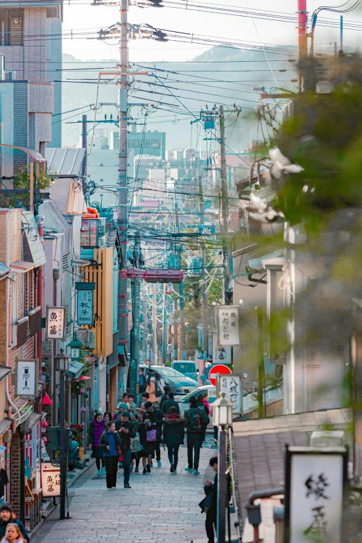 many people are walking along the street in this busy city