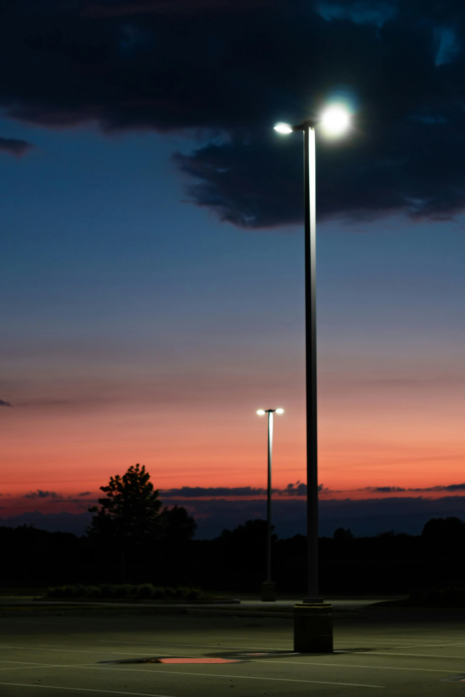 the light post is set in a empty parking lot