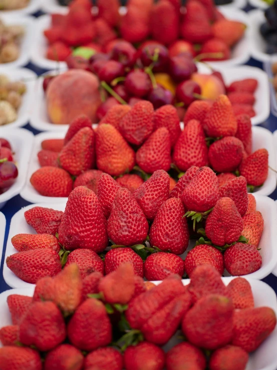 a close up s of some strawberries in bowls