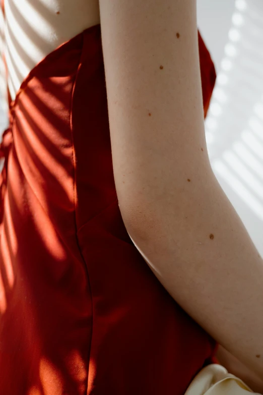 a woman wearing a red dress looking down