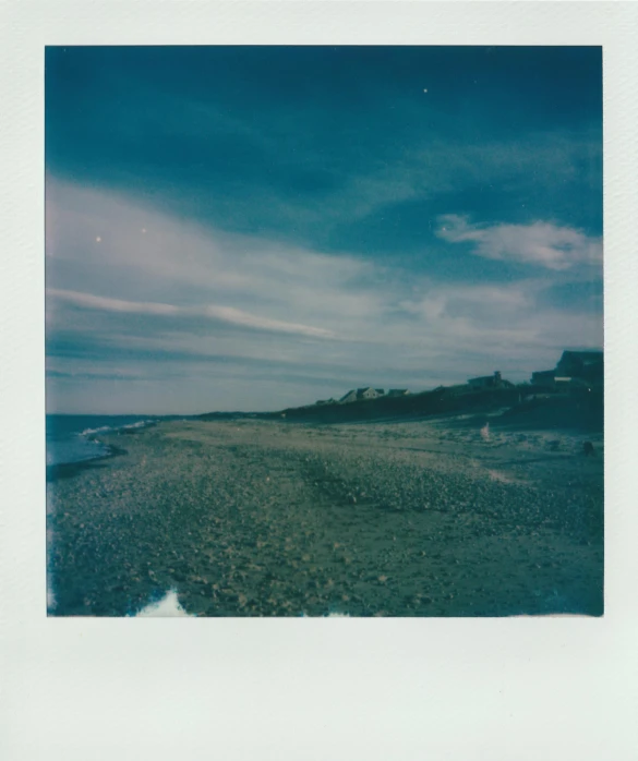 the image shows a beach and ocean with very little sand