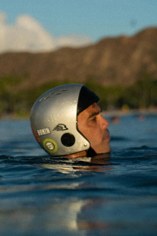 a man in the water with a helmet on