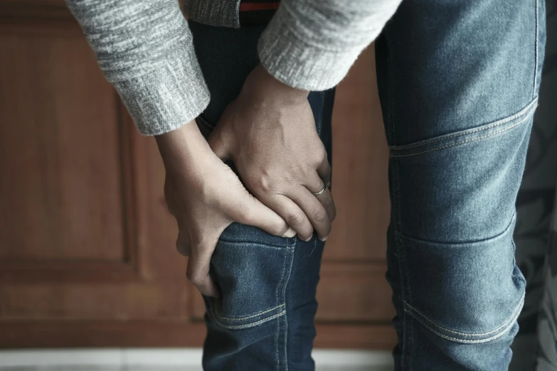 two people holding hands over their back legs