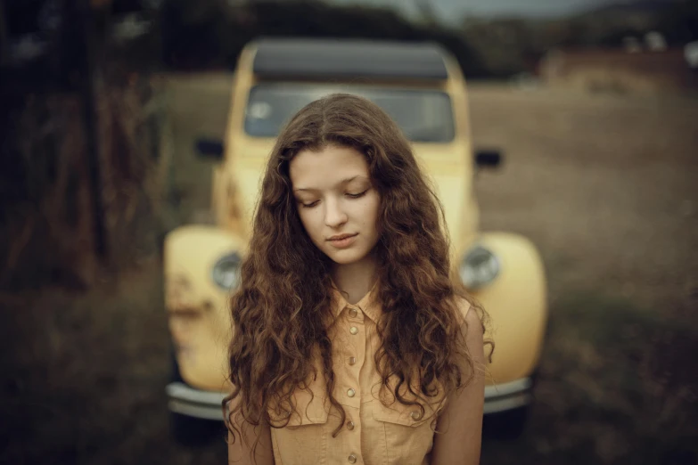 a woman that is looking down near a bus