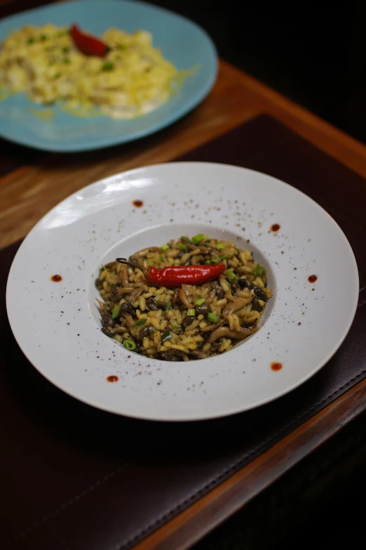 two plates filled with food on top of a wooden table