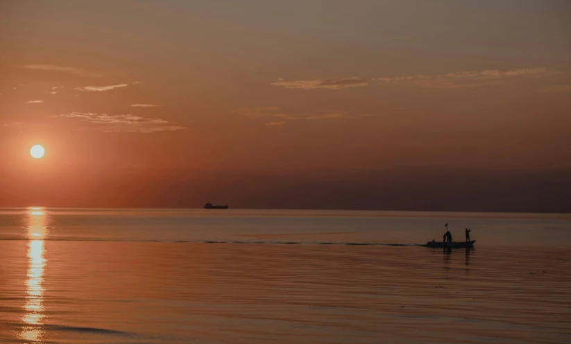 a couple of people are rowing a boat in the water