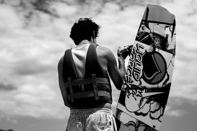 a woman in a bathing suit holds a skateboard