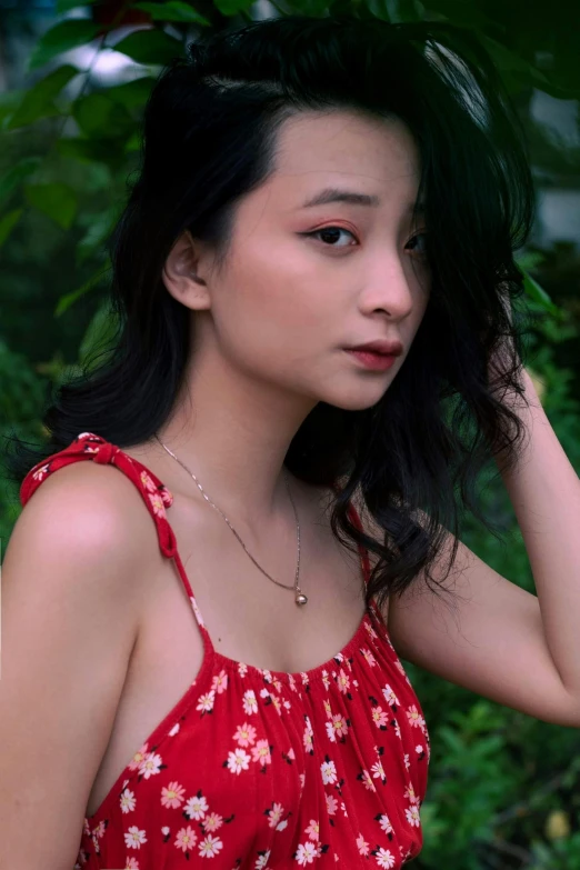 asian girl wearing red dress in the middle of a forest