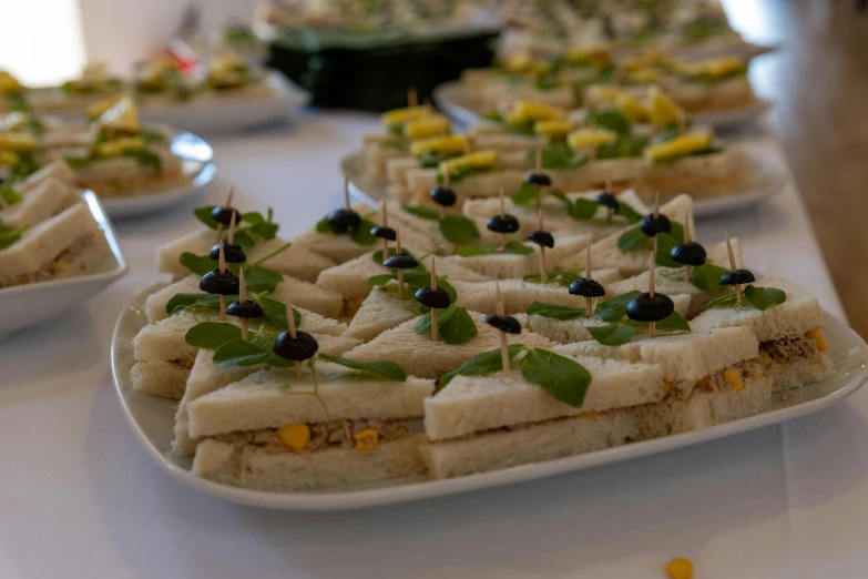 finger food items on white plates placed on a table