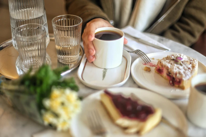 there is a table that has plates of food and cups