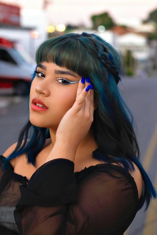 woman with green and blue hair using her mobile phone