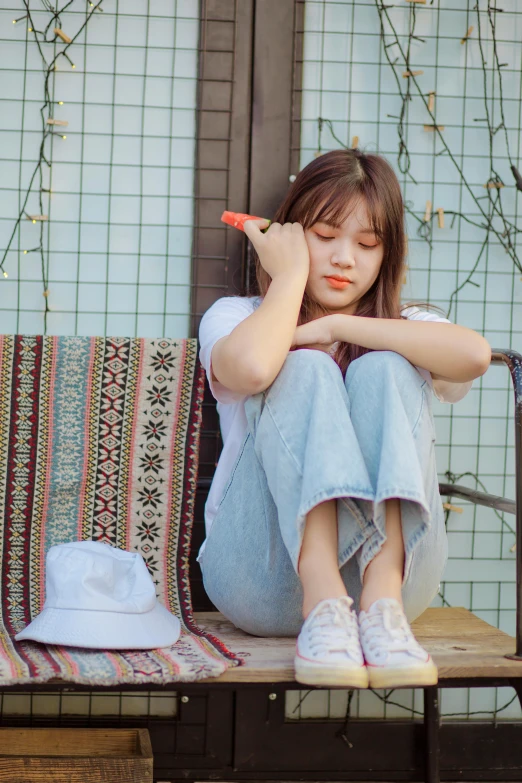 a woman sitting on a bench with her arms crossed