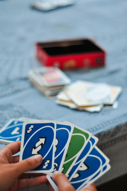 a person is picking up cards from their table