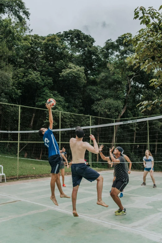 people playing volleyball and having fun on a court