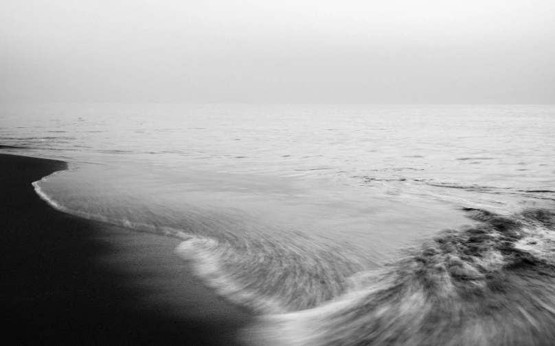 a beach scene with waves in the water