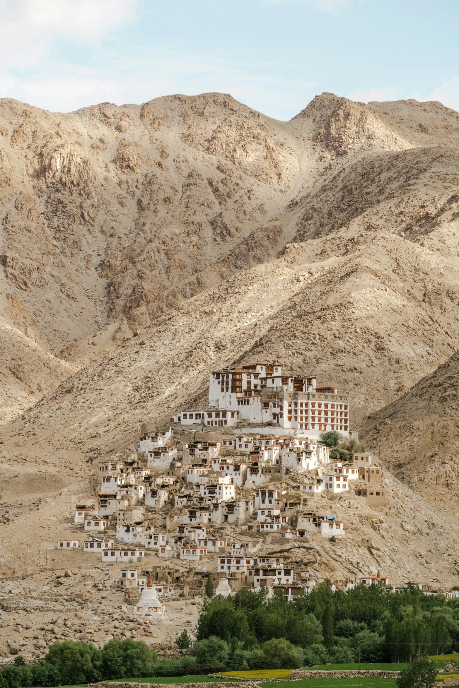 a hillside town sitting in the desert