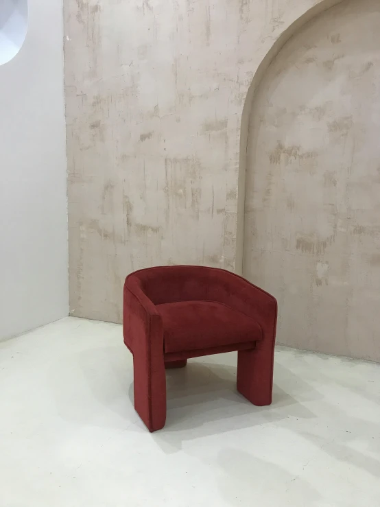 a red chair is sitting in the corner