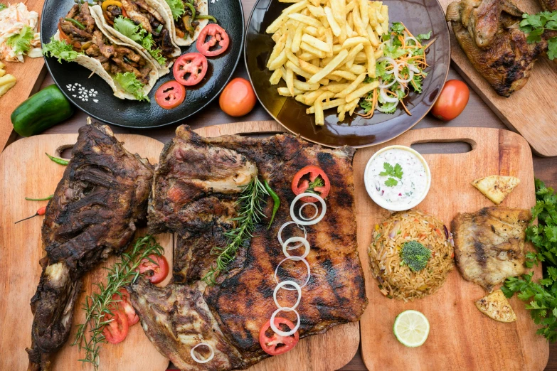 a tray of food that includes steak, pasta, and salads