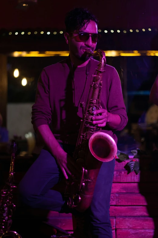 a man that is standing up with a saxophone