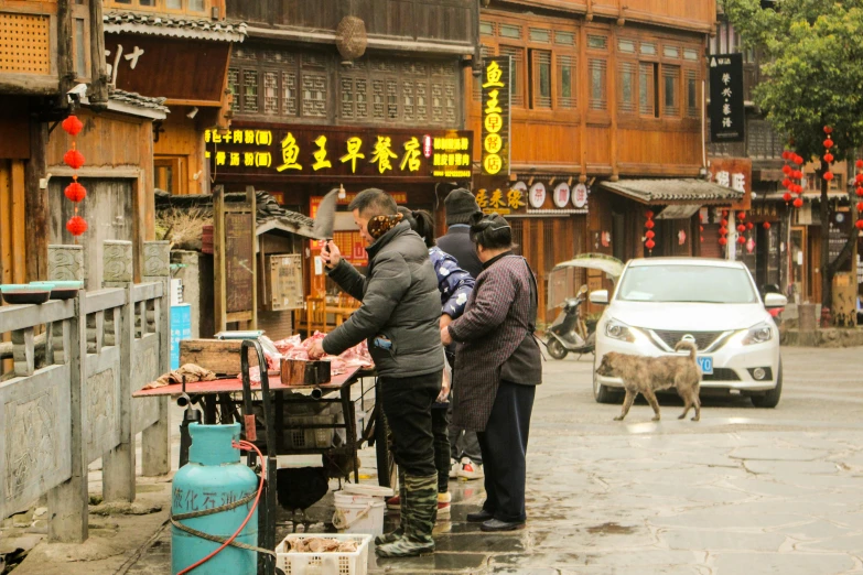 people are shopping outside on a street corner