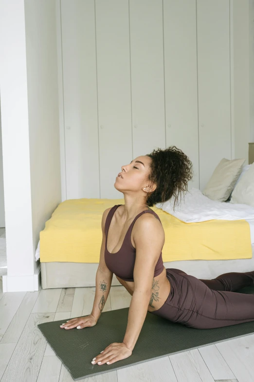 a woman is doing yoga on a mat