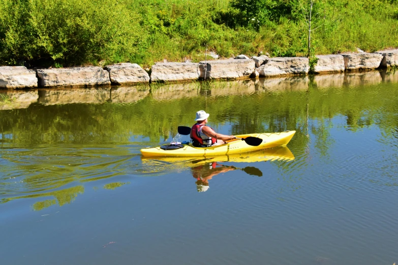 the man is kayaking in the calm water