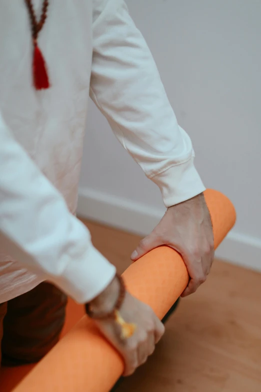 a man with his hand on a carrot roll