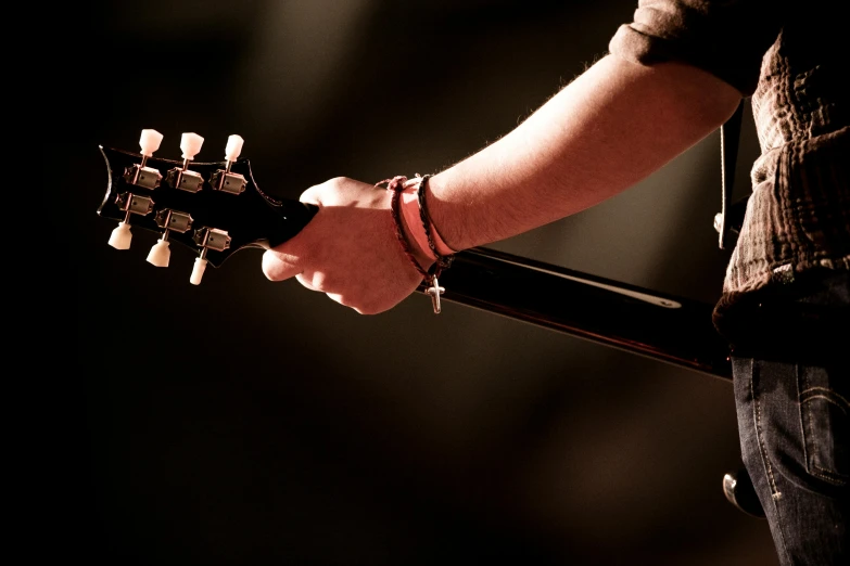 a man that is holding onto his guitar