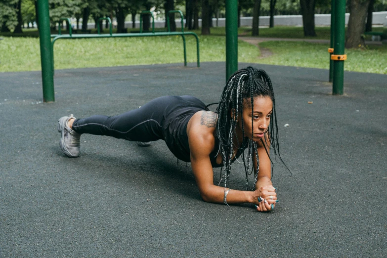 an attractive woman doing exercises on a playground