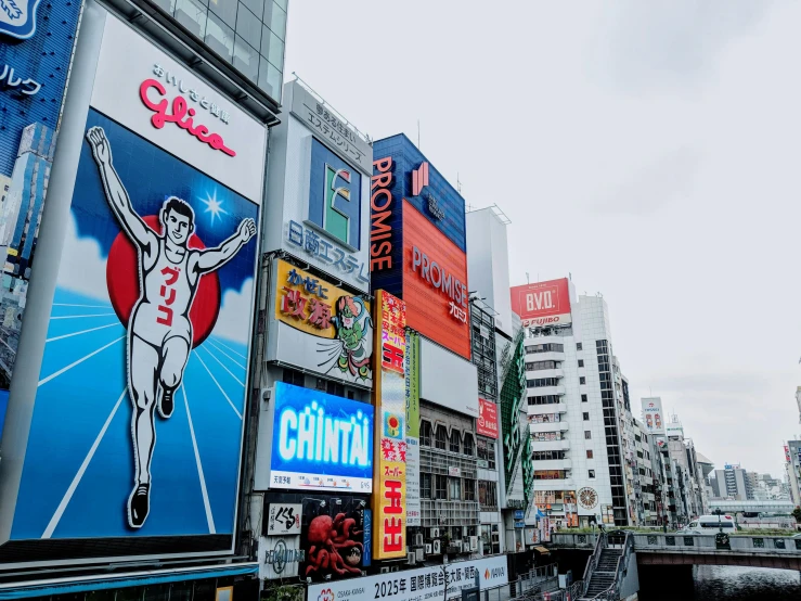 a very crowded street with many colorful advertits