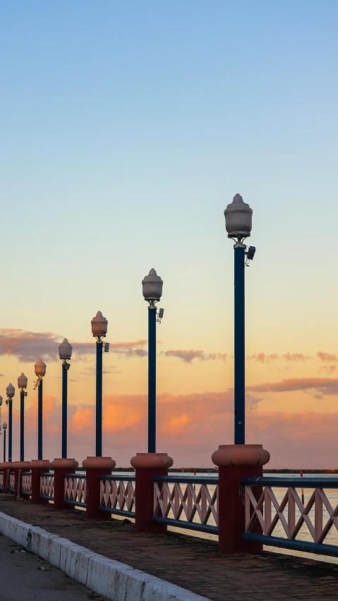 there is a line of lights along the boardwalk