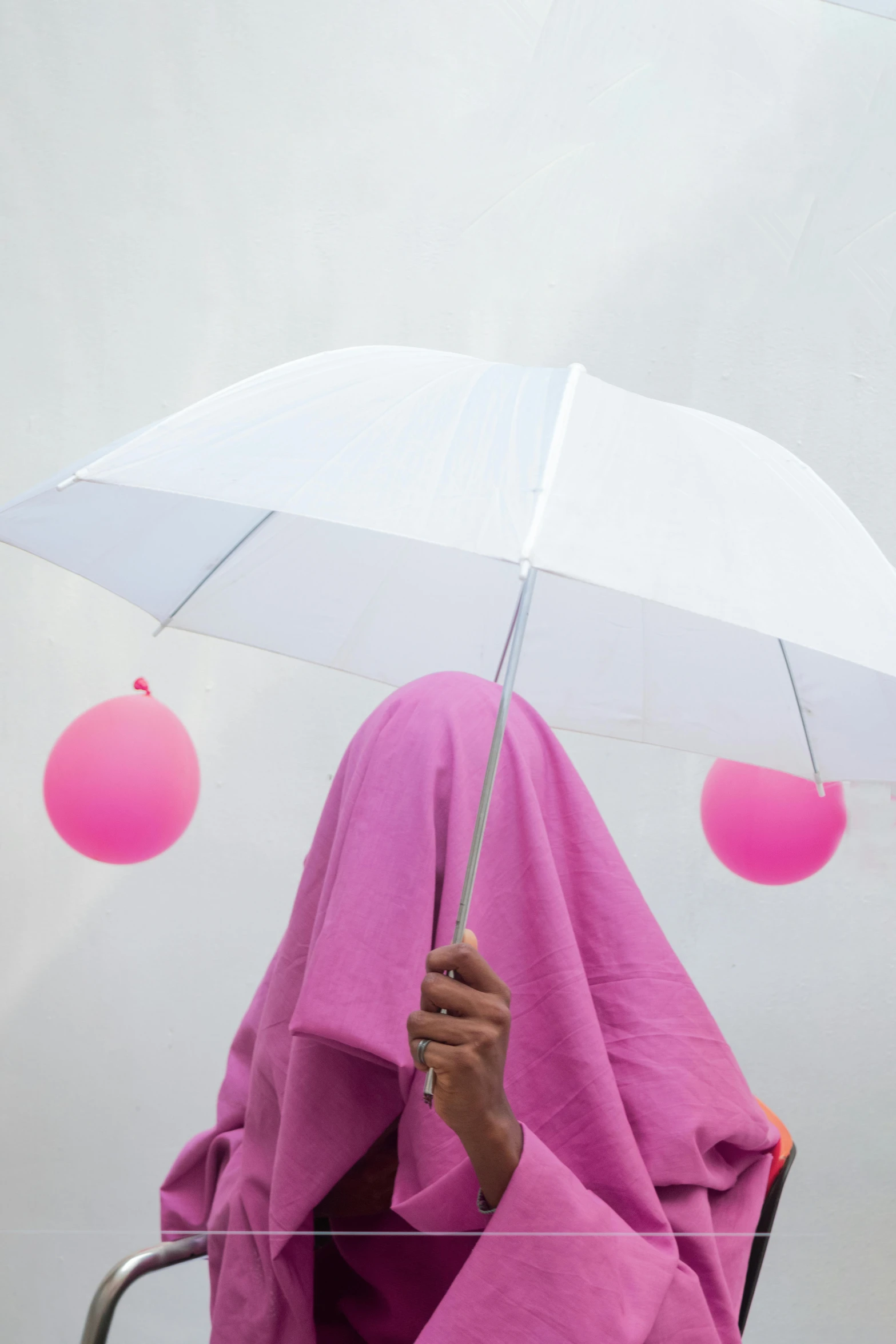 woman in purple robe holding an umbrella over her head