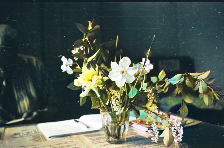 a glass vase filled with flowers on top of a table