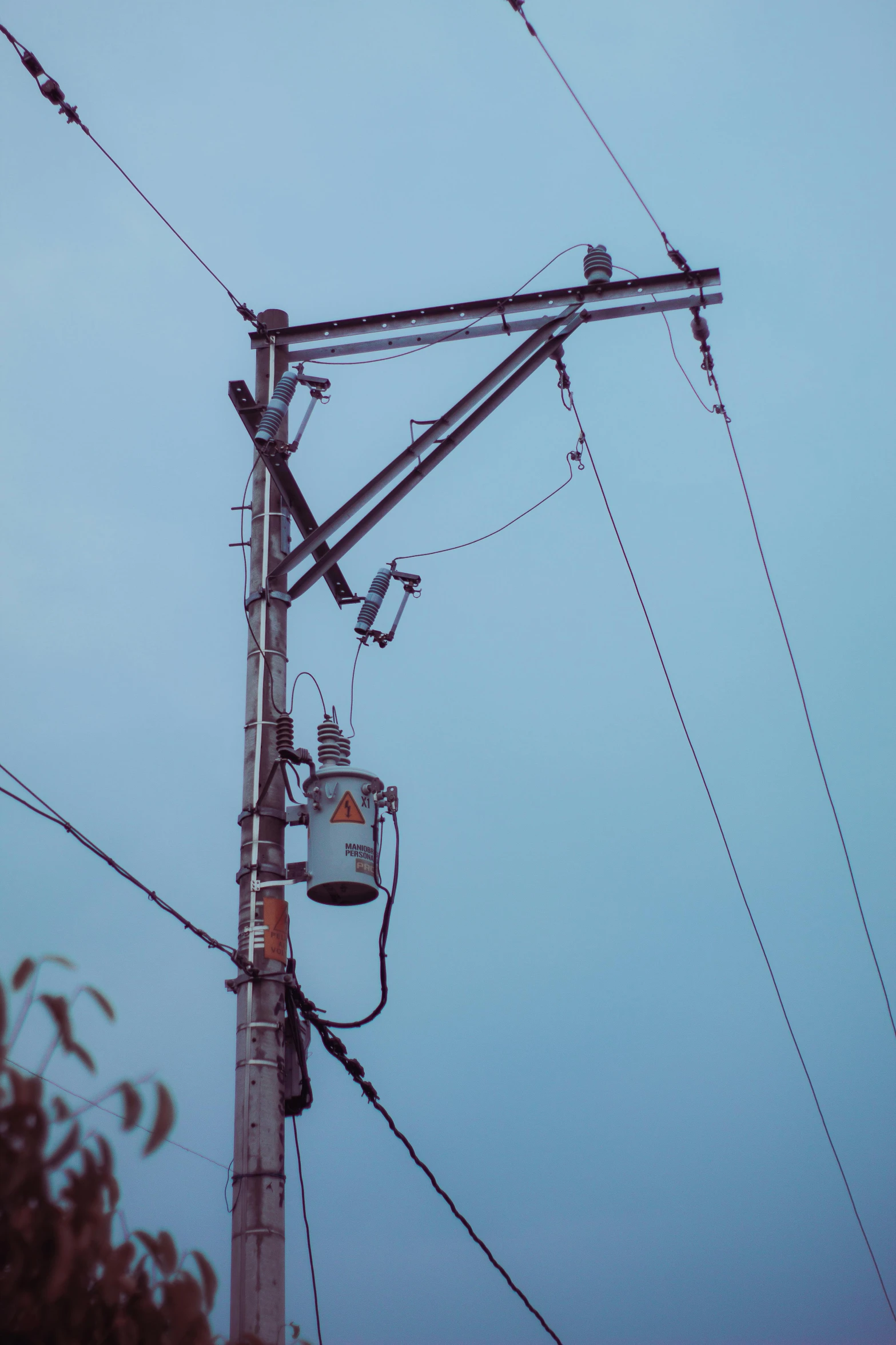 an electrical pole with wires hanging from it