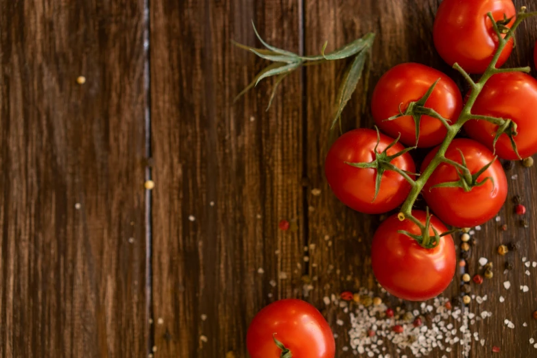 tomatoes have green stems and are on the table