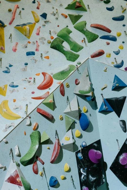 an aerial view of a climbing wall with several different colored plastic objects