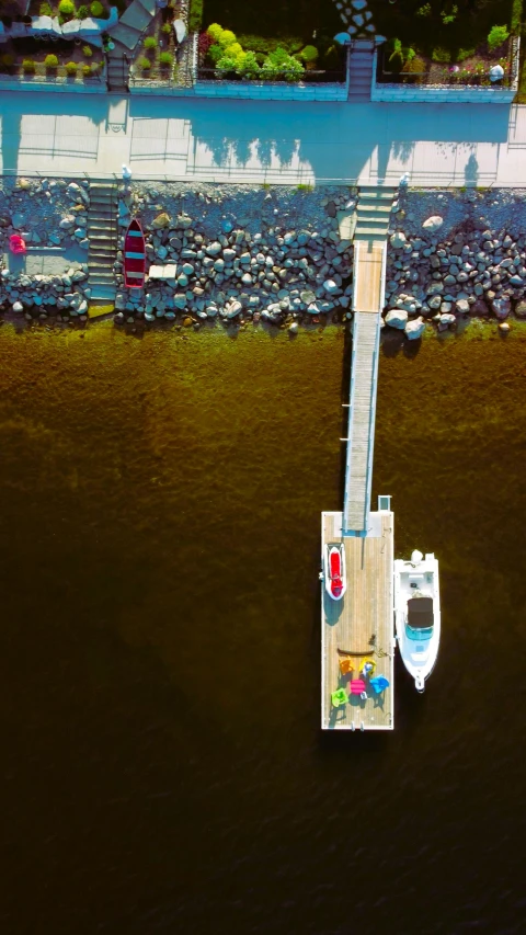 a boat dock with people on it near the ocean