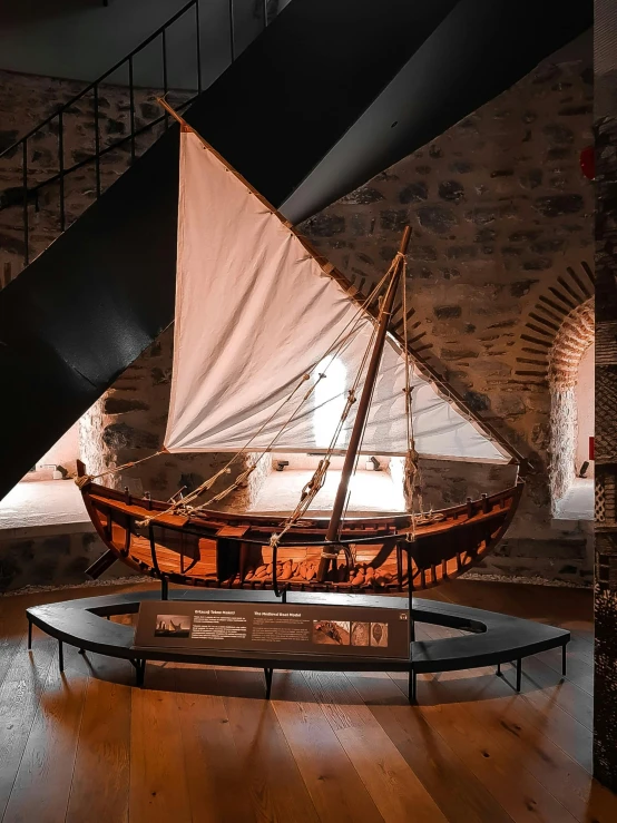 a small boat is on display at a museum