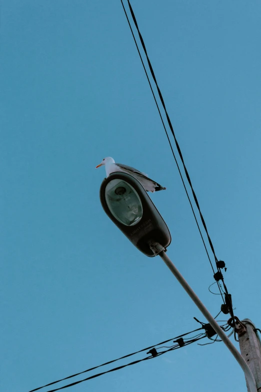 the clock is hanging from the pole with no electricity