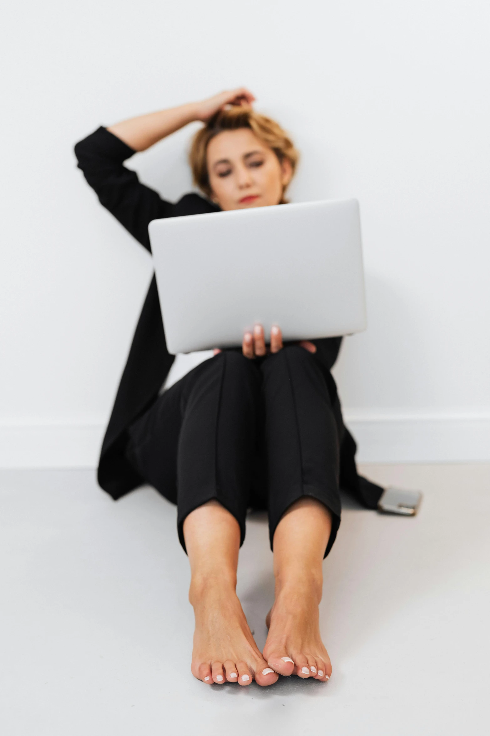 a woman with no shoes using a laptop