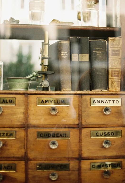 the desk has many books on it and a glass window behind it