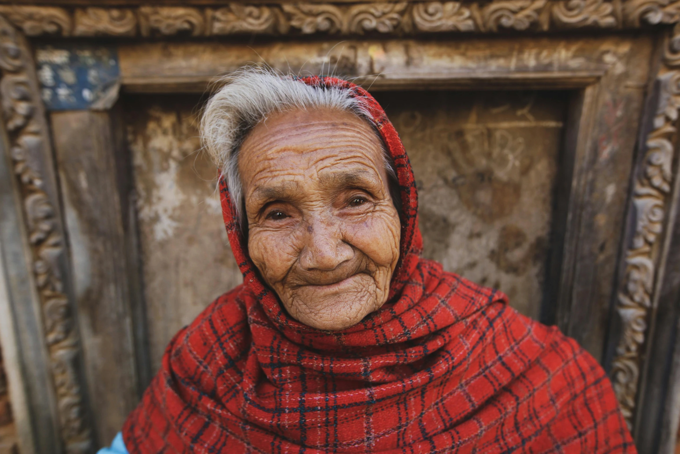 a woman in a red scarf poses for a picture